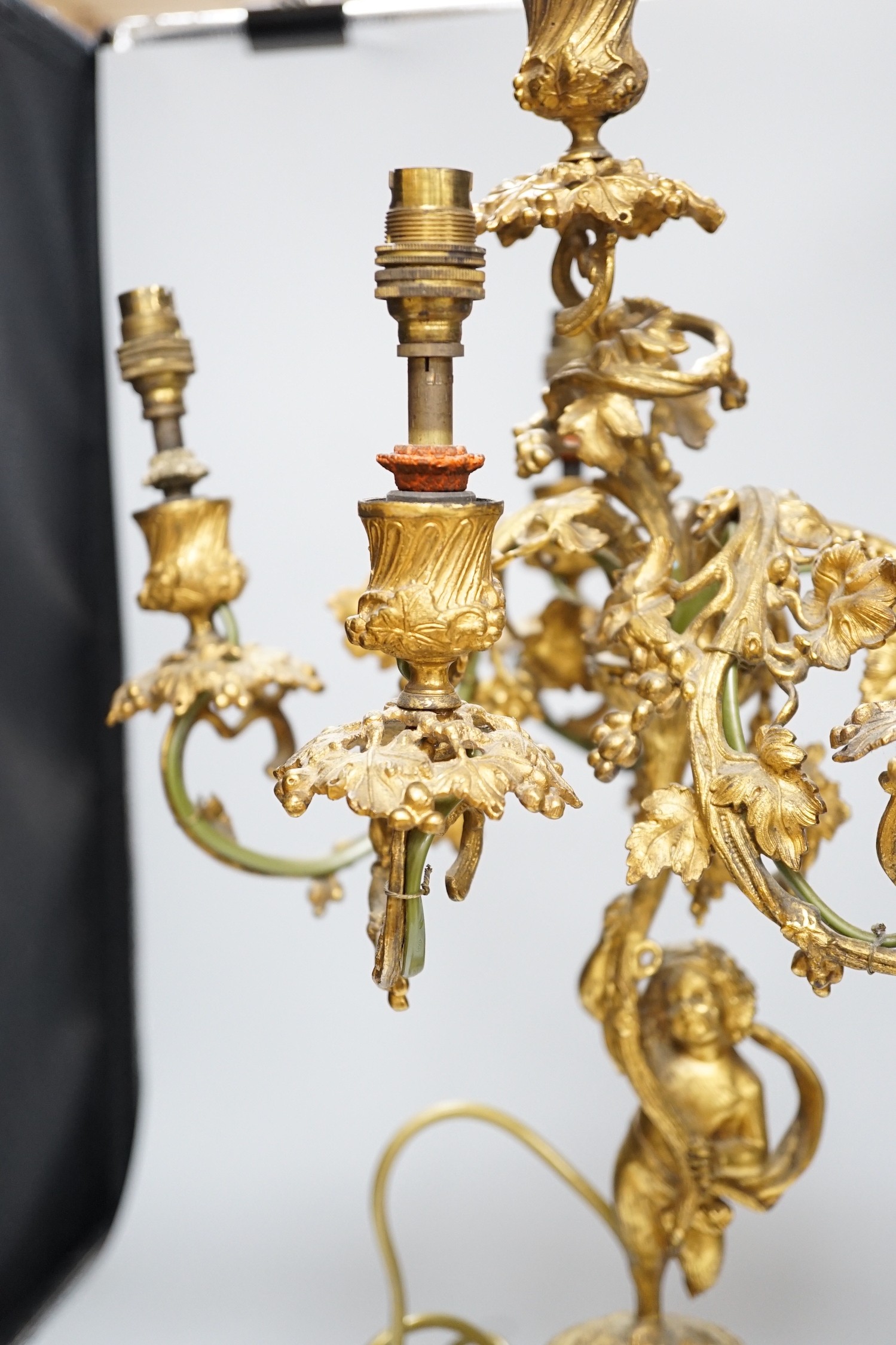An ornate six branch ormolu cherub candelabrum, converted to a lamp, 54cms high